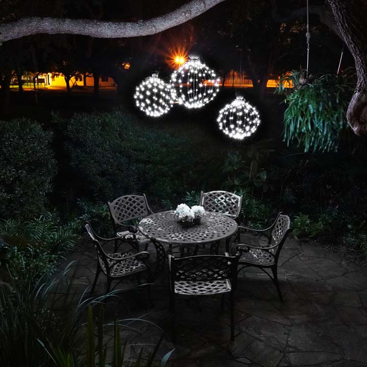 Three stagger-hung GLOWB light spheres create the perfect lighting over this cozy patio table.