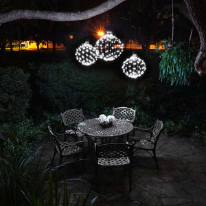 Three stagger-hung GLOWB light spheres create the perfect lighting over this cozy patio table.