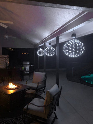 This photo was take by a customer in Orlando Florida. It shows three hanging GLOWBs powered by batteries in a beautiful display next to their firepit.